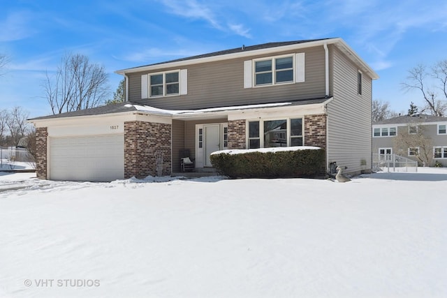 traditional-style home featuring an attached garage and brick siding