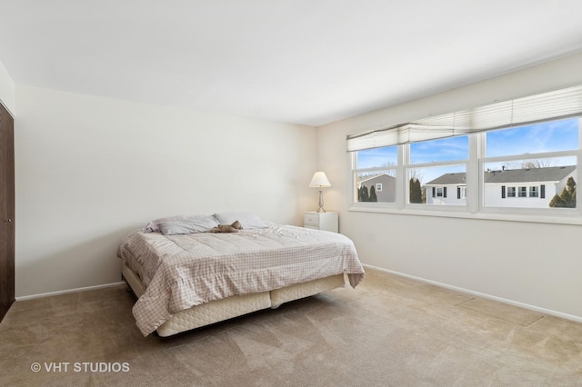 bedroom with carpet floors and baseboards