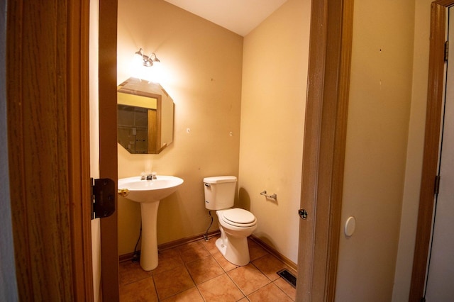 bathroom featuring tile patterned floors, toilet, and sink