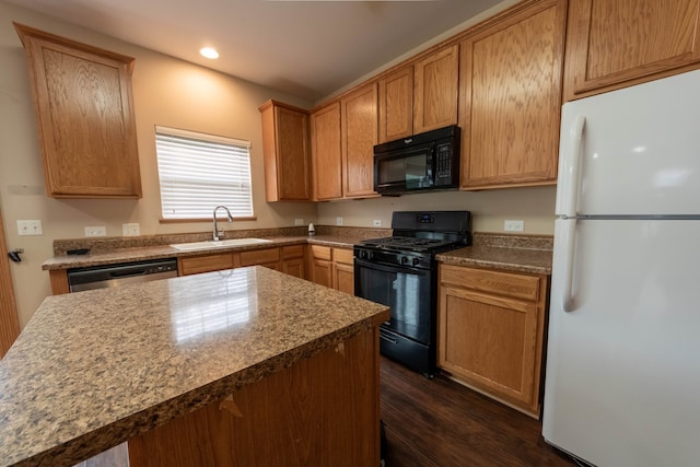 kitchen featuring sink, dark wood-type flooring, and black appliances