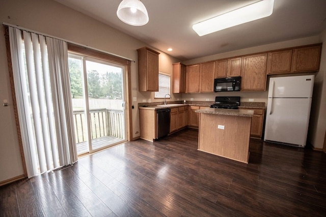 kitchen with a center island, sink, dark hardwood / wood-style floors, and black appliances