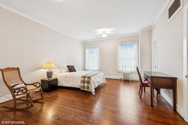 bedroom with radiator heating unit, dark wood-type flooring, and ornamental molding