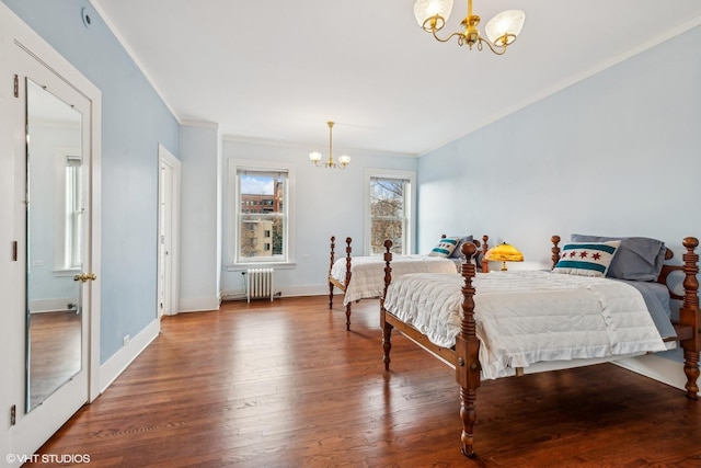 bedroom with radiator heating unit, crown molding, and a chandelier