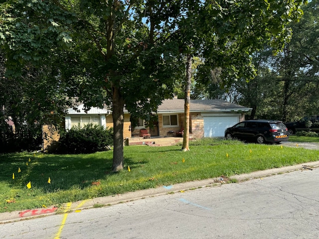 view of front of home featuring a front yard and a garage