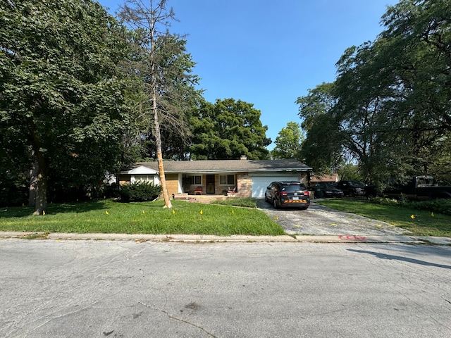 ranch-style home with a garage and a front lawn