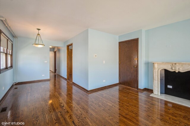 unfurnished living room with dark hardwood / wood-style floors and a fireplace