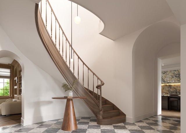 staircase with a high ceiling