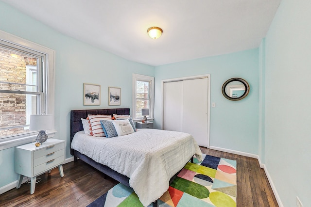 bedroom with dark hardwood / wood-style flooring and a closet