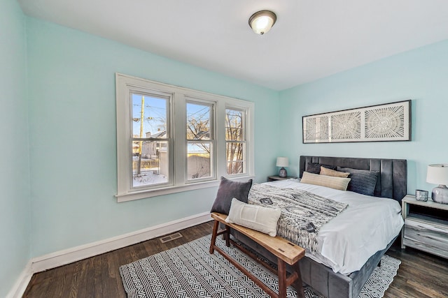 bedroom with dark hardwood / wood-style flooring