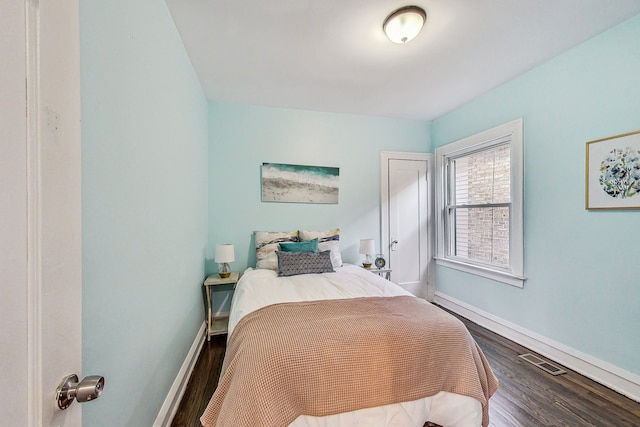 bedroom with hardwood / wood-style floors