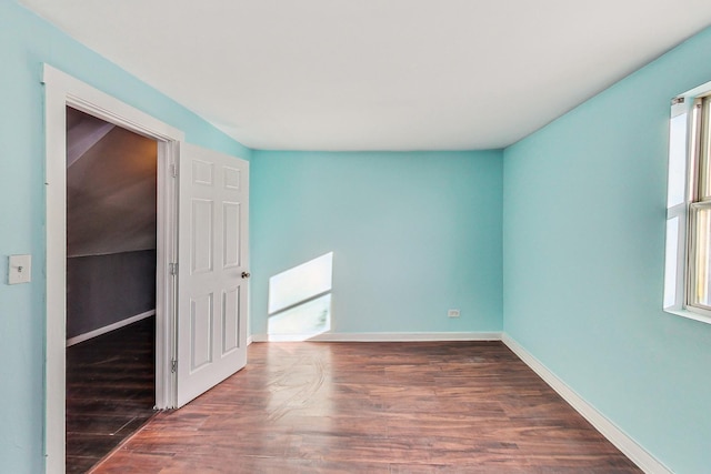 unfurnished room featuring dark wood-type flooring