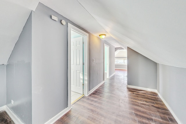 bonus room featuring wood-type flooring and vaulted ceiling