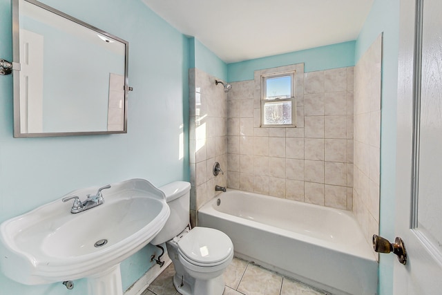 full bathroom featuring sink, tile patterned floors, tiled shower / bath, and toilet