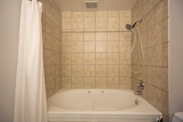 bathroom with shower / bath combo with shower curtain