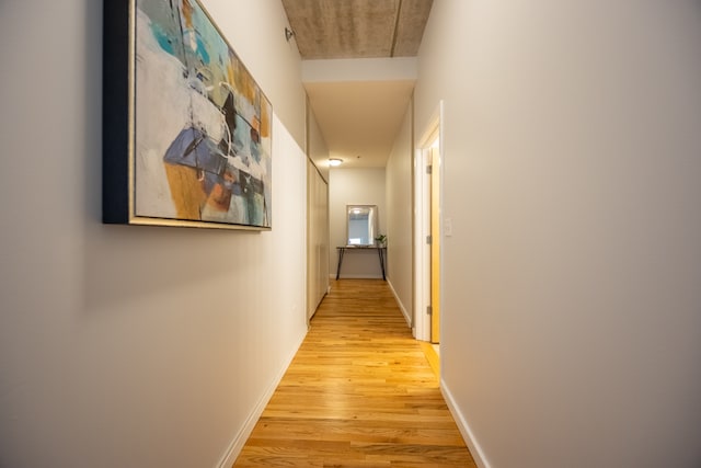 hallway with light hardwood / wood-style flooring