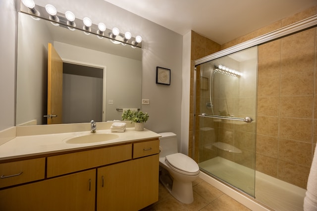 bathroom featuring an enclosed shower, toilet, vanity, and tile patterned flooring