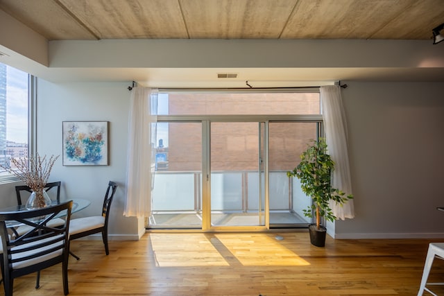 interior space with wood ceiling and light hardwood / wood-style floors