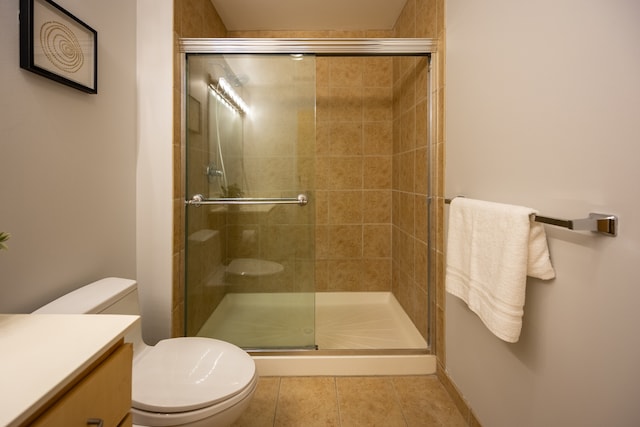 bathroom featuring walk in shower, toilet, tile patterned floors, and vanity