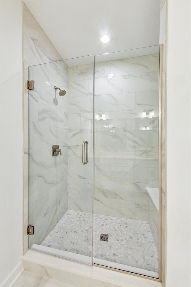 bathroom featuring an enclosed shower and tile patterned floors