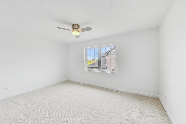 carpeted empty room featuring ceiling fan