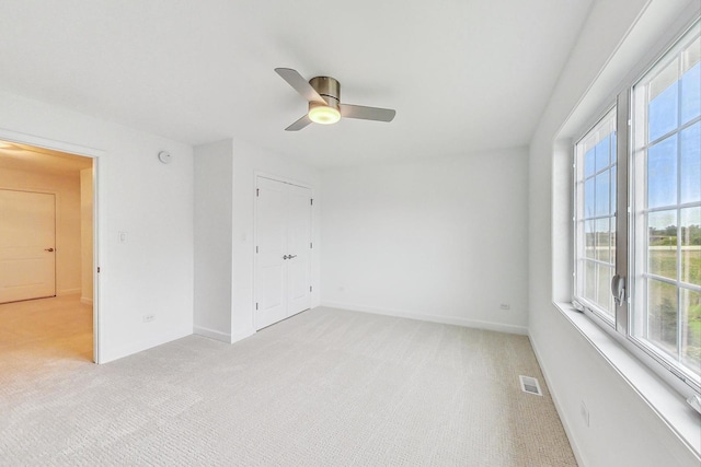 carpeted empty room with ceiling fan