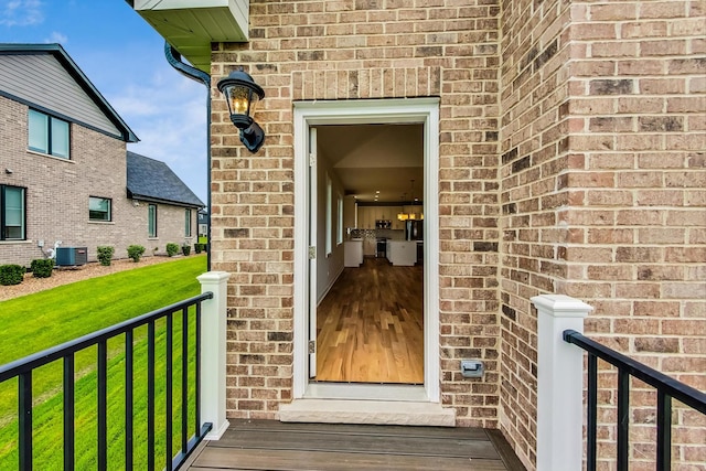 property entrance with central AC and a lawn