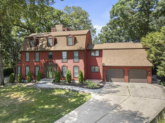 view of front of property with a garage and a front yard