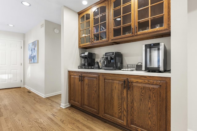 bar featuring light hardwood / wood-style floors