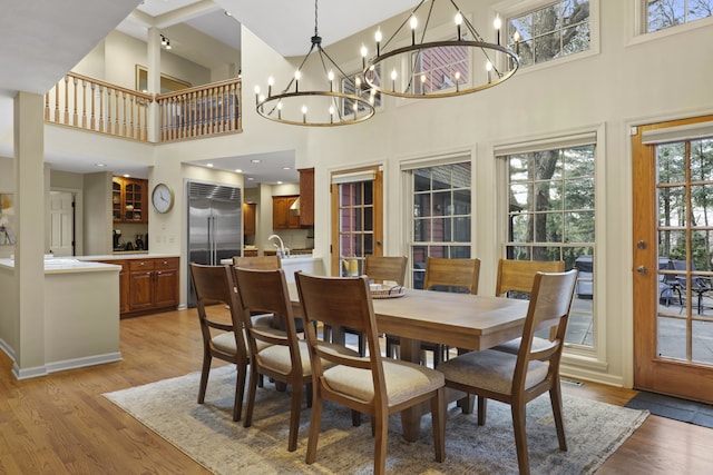 dining space featuring sink and light wood-type flooring