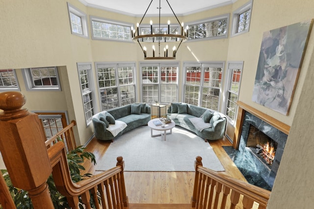 sunroom with a notable chandelier and a high end fireplace