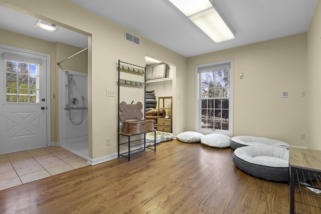 living area with light hardwood / wood-style floors and a healthy amount of sunlight