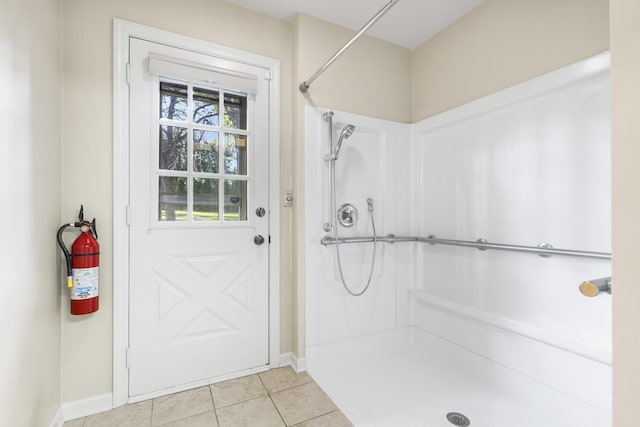 bathroom with tile patterned flooring and a shower