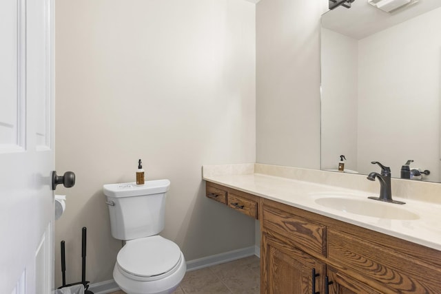 bathroom with vanity, toilet, and tile patterned flooring