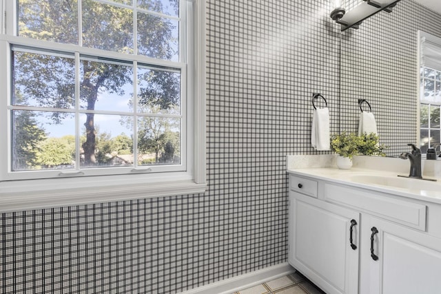 bathroom featuring a healthy amount of sunlight, tile patterned flooring, and vanity