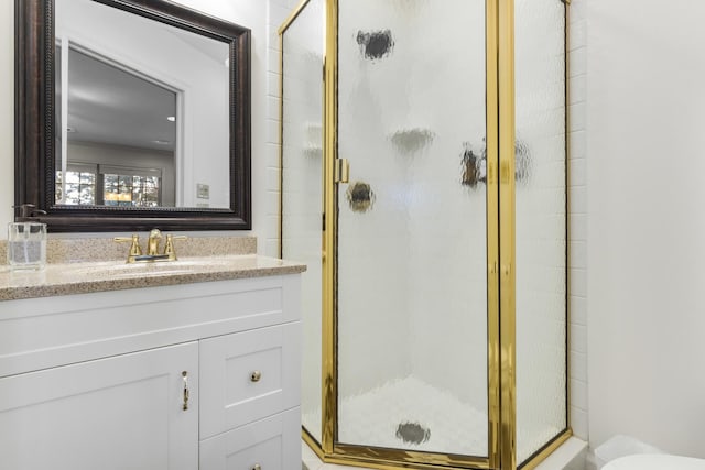 bathroom with an enclosed shower and vanity