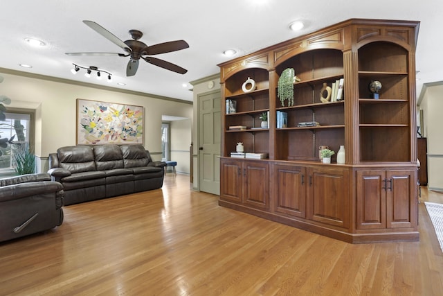 living room featuring ceiling fan, ornamental molding, and light hardwood / wood-style flooring