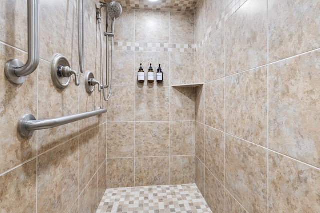 bathroom with a tile shower