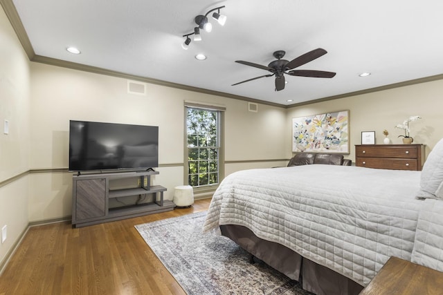 bedroom with ceiling fan, ornamental molding, and dark hardwood / wood-style floors