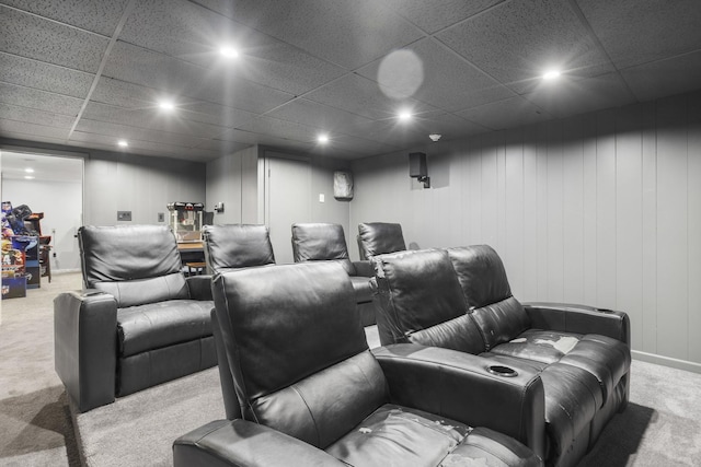 carpeted home theater featuring a drop ceiling