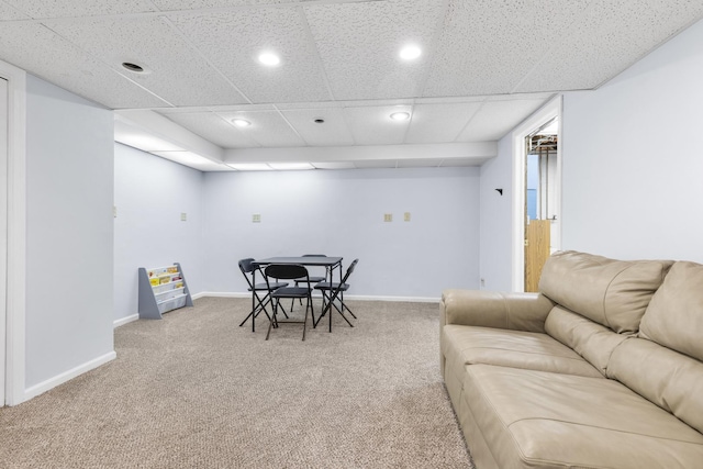 carpeted dining room with a drop ceiling