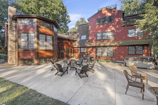 view of patio / terrace featuring a hot tub and central air condition unit