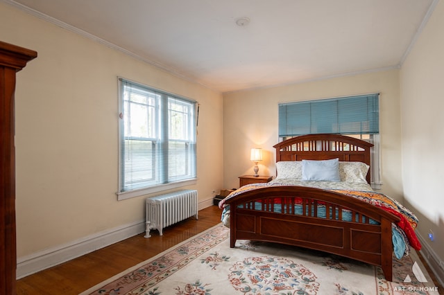 bedroom with radiator, hardwood / wood-style floors, and crown molding