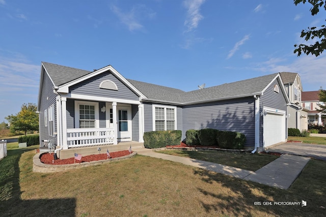 1214 Jerome Ct E, Antioch, IL 60002 - view of front of home featuring covered porch, a front lawn, a garage, asphalt driveway, and a shingled roof