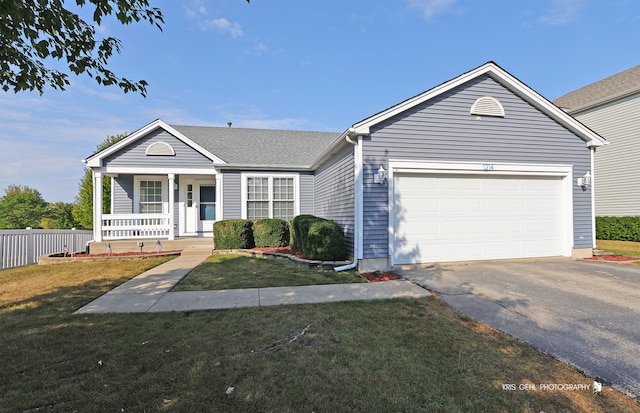 ranch-style house featuring a garage, a front yard, and covered porch