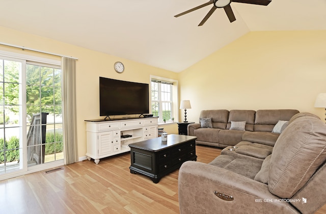 living room with light hardwood / wood-style flooring, vaulted ceiling, and ceiling fan