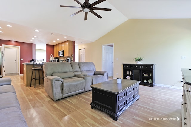 living room featuring light wood-type flooring, lofted ceiling, and ceiling fan