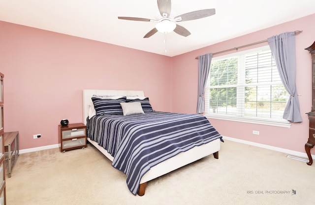 bedroom with ceiling fan and light colored carpet