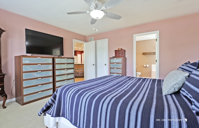 bedroom with carpet flooring, ceiling fan, ensuite bathroom, and a closet