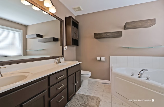 bathroom with vanity, a tub to relax in, toilet, and tile patterned floors