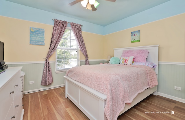 bedroom with ceiling fan and light wood-type flooring